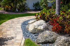 paver walkway large rocks in garden bed