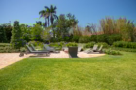 Backyard landscaping green lawn patio fire pit outdoor seating 
