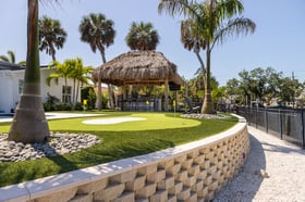 artificial turf putting green backyard retaining wall tiki hut 4